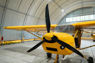Yellow airplane glider in the hangar. 