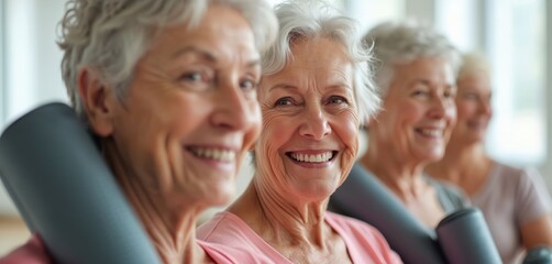 Group senior women portrait in studio. Elderly ladies hold yoga mats smiling. Smiling old females workout in class. Retirement club friends together at training. Wellness concept.