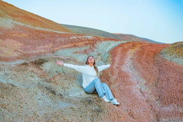 Girl walking in the mountains of Khizi at sunset