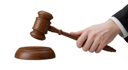 Hand Holding Wooden Gavel Above Sound Block Against Black Background