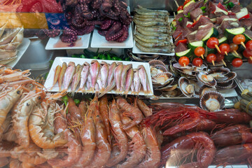 Assorted Mediterranean Seafood For Sale, Trendy Mercado de Atarazanas Market, Malaga Spain.  Fresh Oysters, Lobster, Crabs, Shrimps, Prawns, Scallops and Fish Kebab.