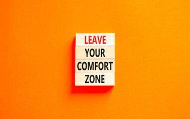 Leave your comfort zone symbol. Concept words Leave your comfort zone on beautiful wooden blocks. Beautiful orange paper background. Business psychological Leave your comfort zone concept. Copy space.