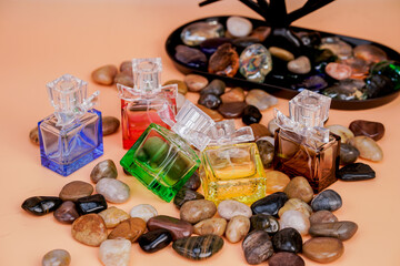Colorful glass perfume containers with artistic caps in a beauty-themed layout.