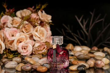 Minimalist perfume display with reflective background and natural decorative props.