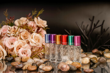 Soft pink floral background paired with premium fragrance containers.