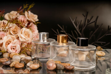 Romantic fragrance bottles styled with soft pink flowers and decorative stones.