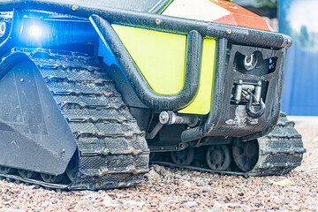 Close-up of a black and yellow-green ATV with textured surface, rugged treads, off-road vehicle,...