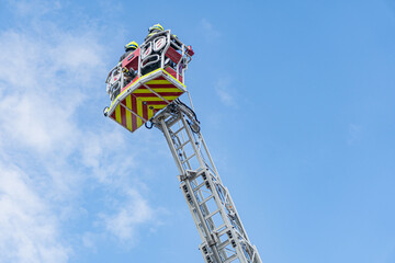 Industrial crane red, white in vertical position with extended jib Heavy marking on crane Overcast...