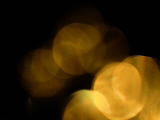 Abstract bokeh scene. Golden light leaks on black color background for design. Light effect.