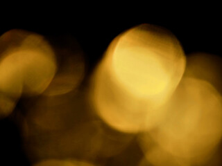 Abstract bokeh scene. Golden light leaks on black color background for design. Light effect.