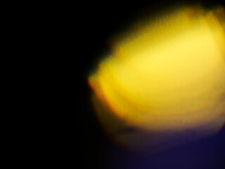 Abstract bokeh scene. Golden and blue glowing light leaks on black color background for design....