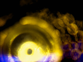Abstract bokeh scene. Golden and blue glowing light leaks on black color background for design....