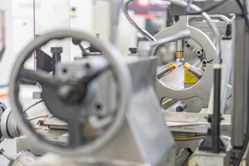 Industrial scene with mechanical equipment, including a large circular component and surrounding...