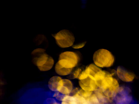 Abstract bokeh scene. Golden and blue glowing light leaks on black color background for design. Light effect.