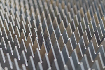 Close-up view of metallic blades in a fan pattern, reminiscent of an aircraft engines turbine...