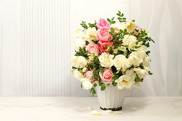 Beautiful still life with flowers of cream tea rose and rose hips on elegant modern table,Abstract flower arrangement. template for your design , minimalist beauty concept, flower card