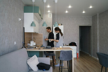 Two friends engage in a lively conversation while preparing food