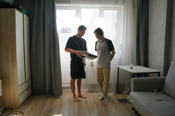 Friends enjoy discussing and playing with a constructor car