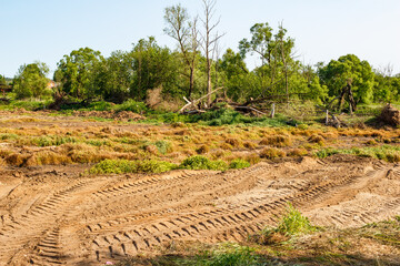 Filling a marshy area in a field with sand
