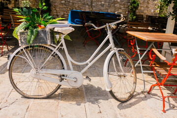 Vintage bicycle resting on a Mediterranean alley. Casual transportation, timeless street charm, and rustic urban tranquility.