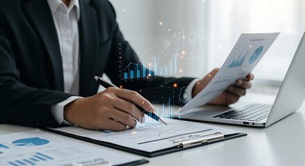 Businessperson reviewing financial data graphs charts laptop pen