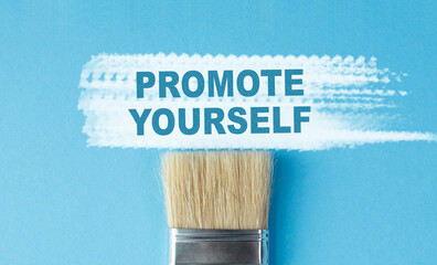 A paintbrush with the word Promote Yourself written on it