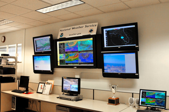 Meteorologist in Work Area in Doppler Radar National Oceanic and Atmospheric Administration NOAA National Weather Service Station Ruskin Florida Tampa  Gulf West Central . Created 06.18.25