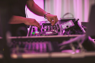 Vibrant nightlife comes alive as a skilled DJ mixes tracks at a bustling event in a stylish venue during an electrifying evening