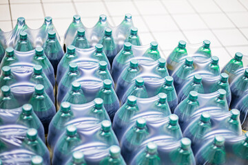 drinks, light and dark beer in plastic bottles in the supermarket