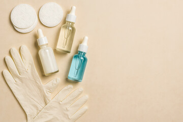 High-Resolution Ultra-Realistic Image of Skincare Dropper Bottles with Cotton Pads, Medical Gloves on a Beige Background &ndash; Ideal for Highlighting Clinical Skincare Routines, Beauty Treatments