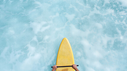 Aerial view of person paddleboarding on clear blue ocean water