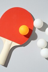 Ping pong racket and balls on light background, flat lay