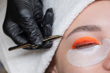Caucasian woman undergoing eyelash lamination procedure. 