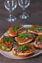 Sandwiches with sausage, egg, tomato and arugula