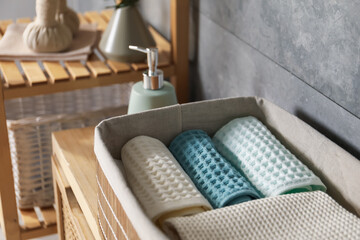Clean waffle towels on wooden dresser in bathroom, closeup