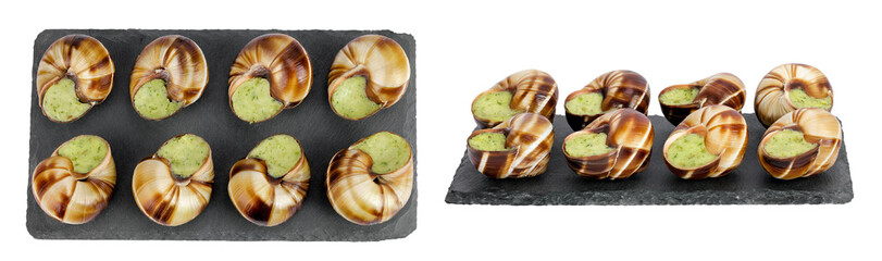 escargot snail filled with garlic and parsley butter on a stone board isolated on white background. Top view. Flat lay