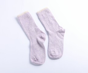Pair of violet wool socks isolated on white, top view