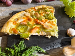 delicious slice of pizza on a granite sliced board is delicious and simple.