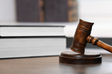 Judge. Gavel and books on wooden table in office, closeup