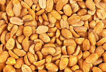 Texture of salted and roasted peanut as background, top view. Chili spicy peanuts.