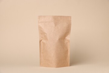 One zipper stand-up pouch on beige background. Mockup for design