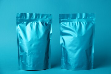 Zipper stand-up pouches on light blue background. Mockup for design