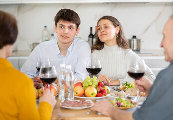 Happy family having dinner together at the festive table at home