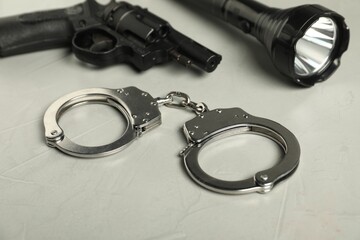 Different police equipment on light grey table, closeup