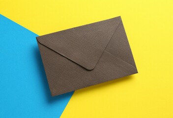 Beautiful invitation envelope on color background, top view