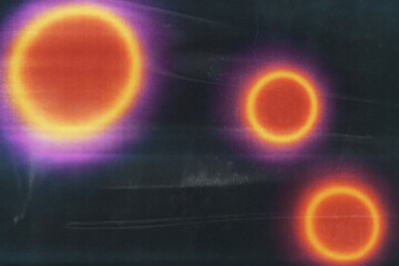 This image features vibrant circles with glowing edges in shades of orange and purple against a black background, evoking a sense of abstract artistry.