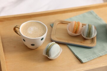 Tray with delicious breakfast on bed indoors, closeup