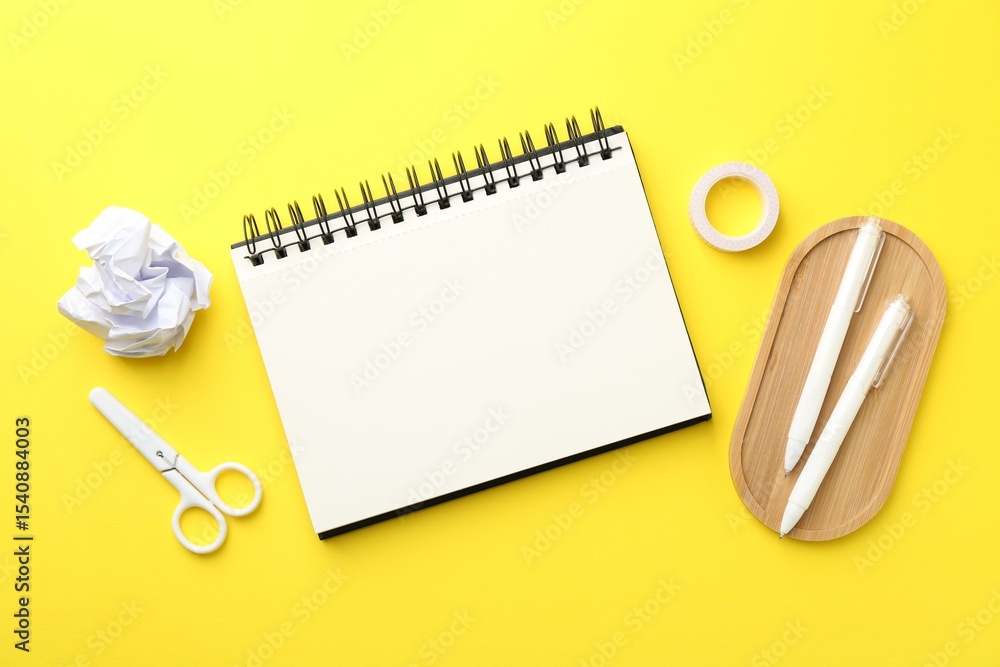 Aufkleber flat lay composition with open blank notebook on yellow background