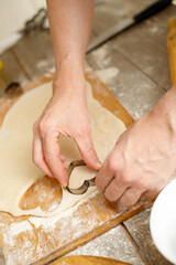 Making Heart Shaped Cookies for Loves Day. Close-up of male hands. Baking concept.