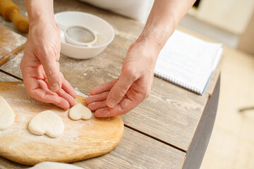 Making Heart Shaped Cookies for Loves Day. Close-up of male hands. Baking concept.